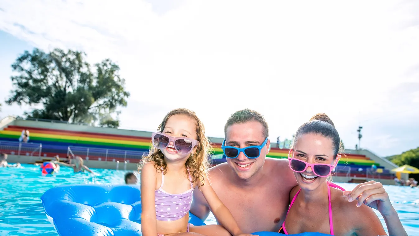 Mother, father and daughter in swimming pool. Sunny summer. Beautiful Leisure Activity Girls Women Men Floating On Water Water Park Young Adult Child Smiling Playful Fun Beauty Bonding Togetherness Relaxation Joy Enjoyment Love Multi Colored Blue Wet Vaca