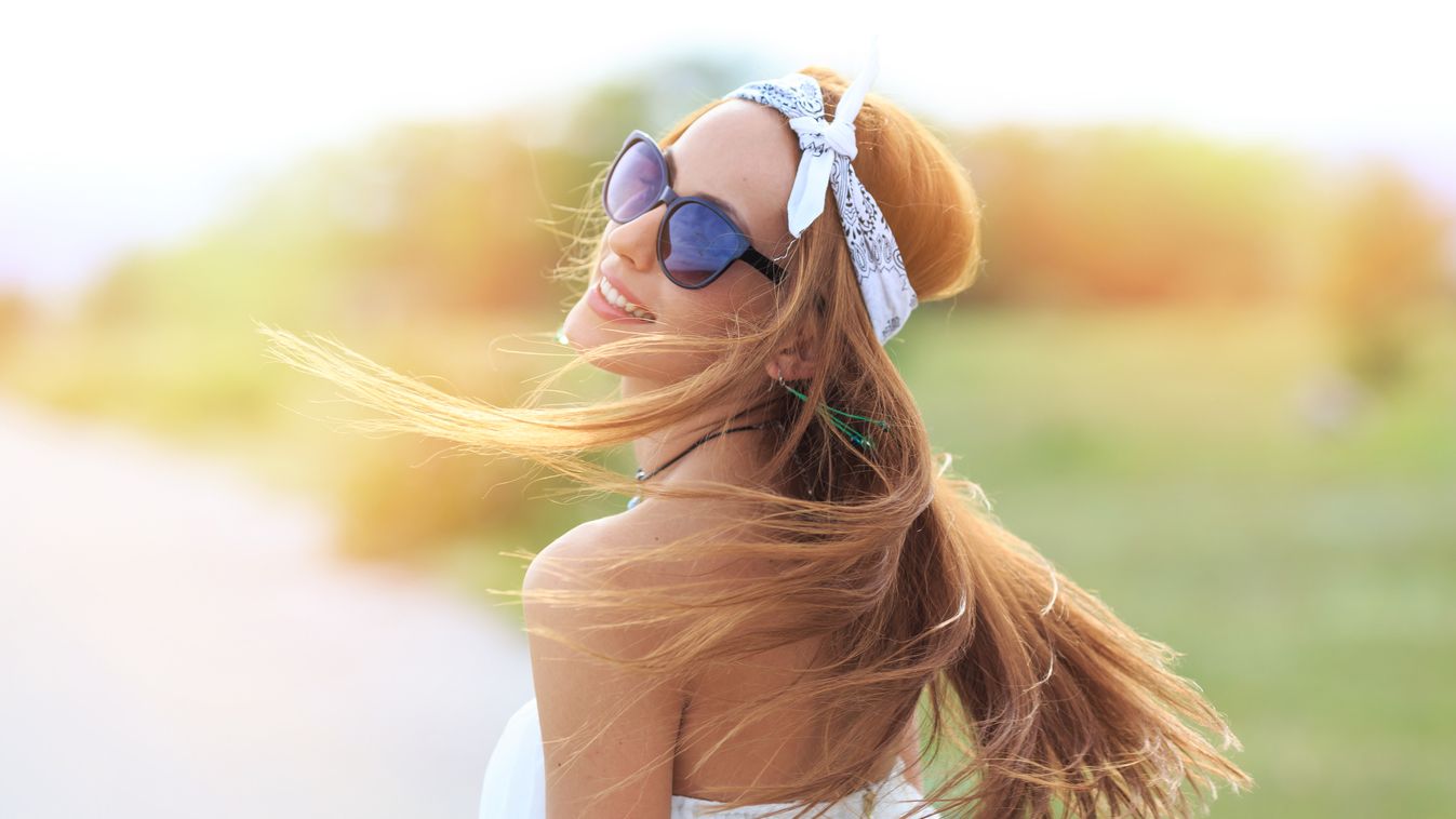 Portrait of young boho woman with flowing hair Boho Focus On Foreground Retro Styled Fashion Portrait Young Women Women Females Copy Space Fashion Model Youth Culture Hippie Lens Flare Headband Grass Young Adult Smiling Playful Fun Caucasian Ethnicity Car