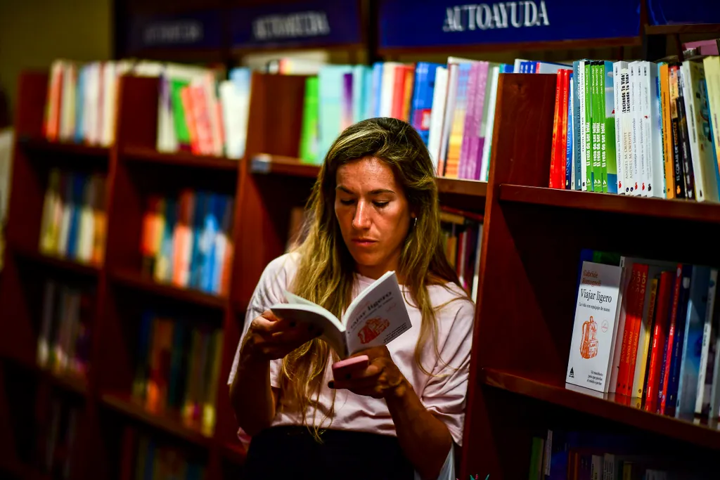 Horizontal BOOKSHOP A woman looks at a book in the "El Ateneo Grand Splendid" bookstore in Buenos Aires, Argentina, on January 9, 2019. - El Ateneo Grand Splendid is a bookshop in Buenos Aires that was named the "world's most beautiful bookstore" by Natio