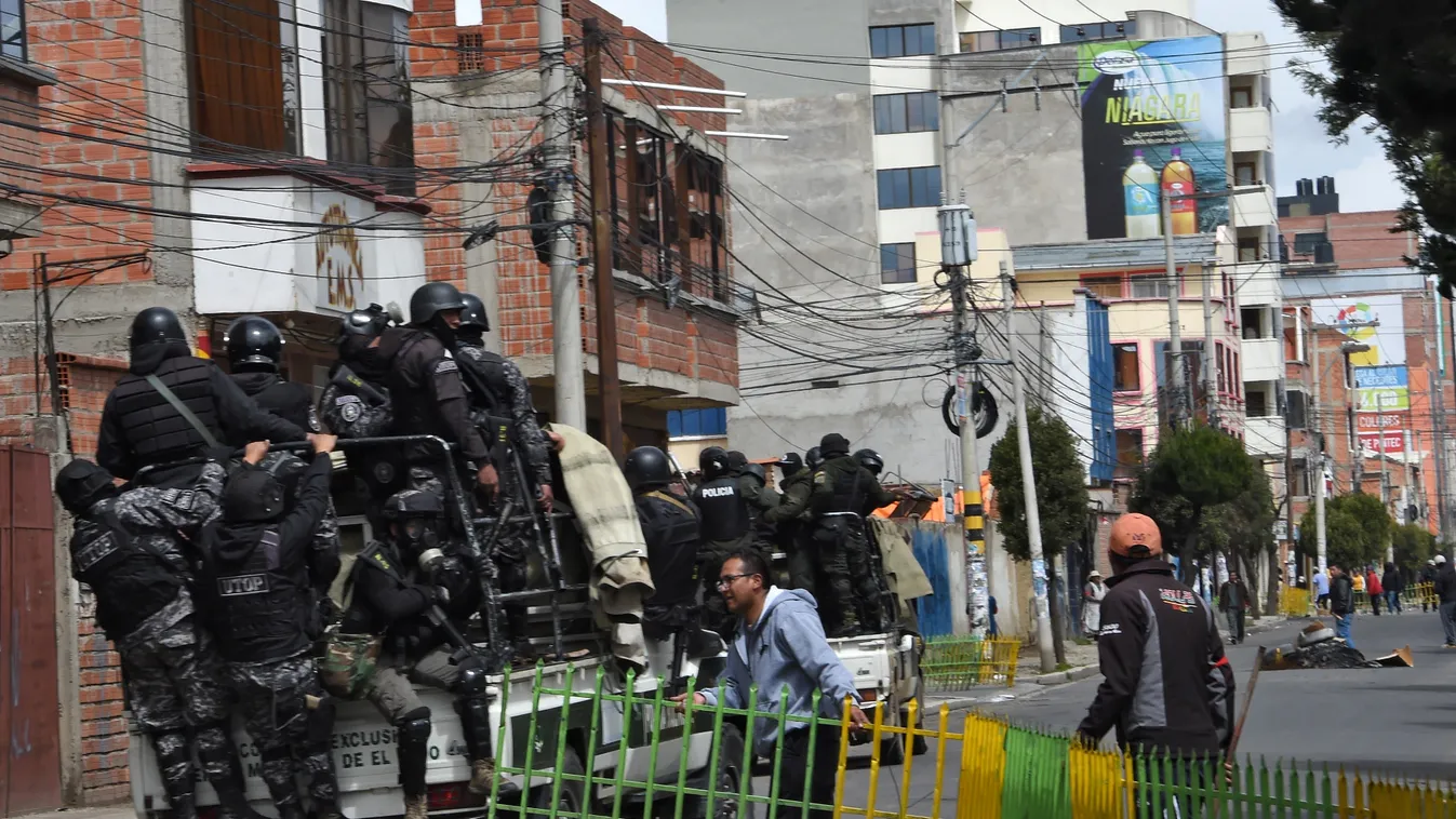 Horizontal Police forces patrol the streets of El Alto on November 11, 2019, a day after the resignation of Bolivia's President Evo Morales. - Morales announced his resignation on Sunday, caving in following three weeks of sometimes-violent protests over 