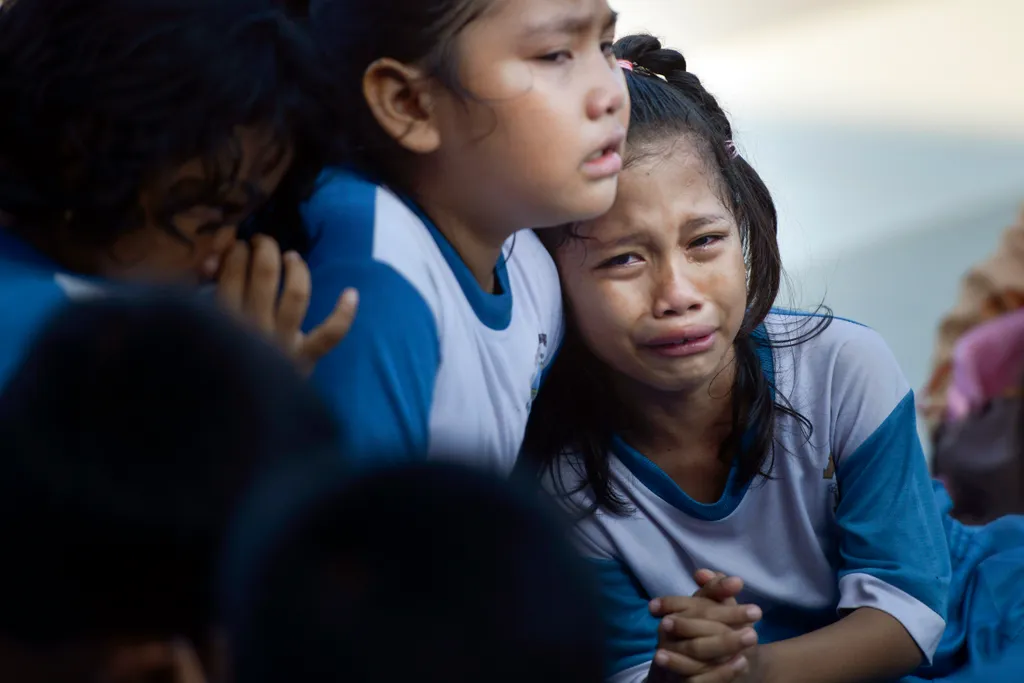 Horizontal PREVENTATIVE MEASURE NATURAL DISASTERS TRAINING CHILD SCHOOLCHILD EMERGENCY EXERCISE LITTLE GIRL IN TEARS AFRAID Indonesian students cry while taking part take part in an earthquake and tsunami drill in Banda Aceh on December 1, 2018. - On Dece