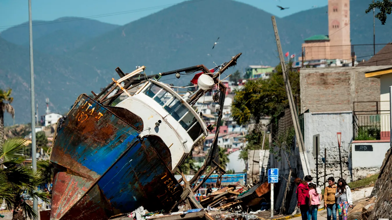A fishing boat that was ran aground by the sea while moored in the port of Coquimbo, some 445 km north of Santiago, during the eve's earthquake on September 17, 2015. A million people were evacuated in Chile after an 8.3-magnitude quake struck offshore in