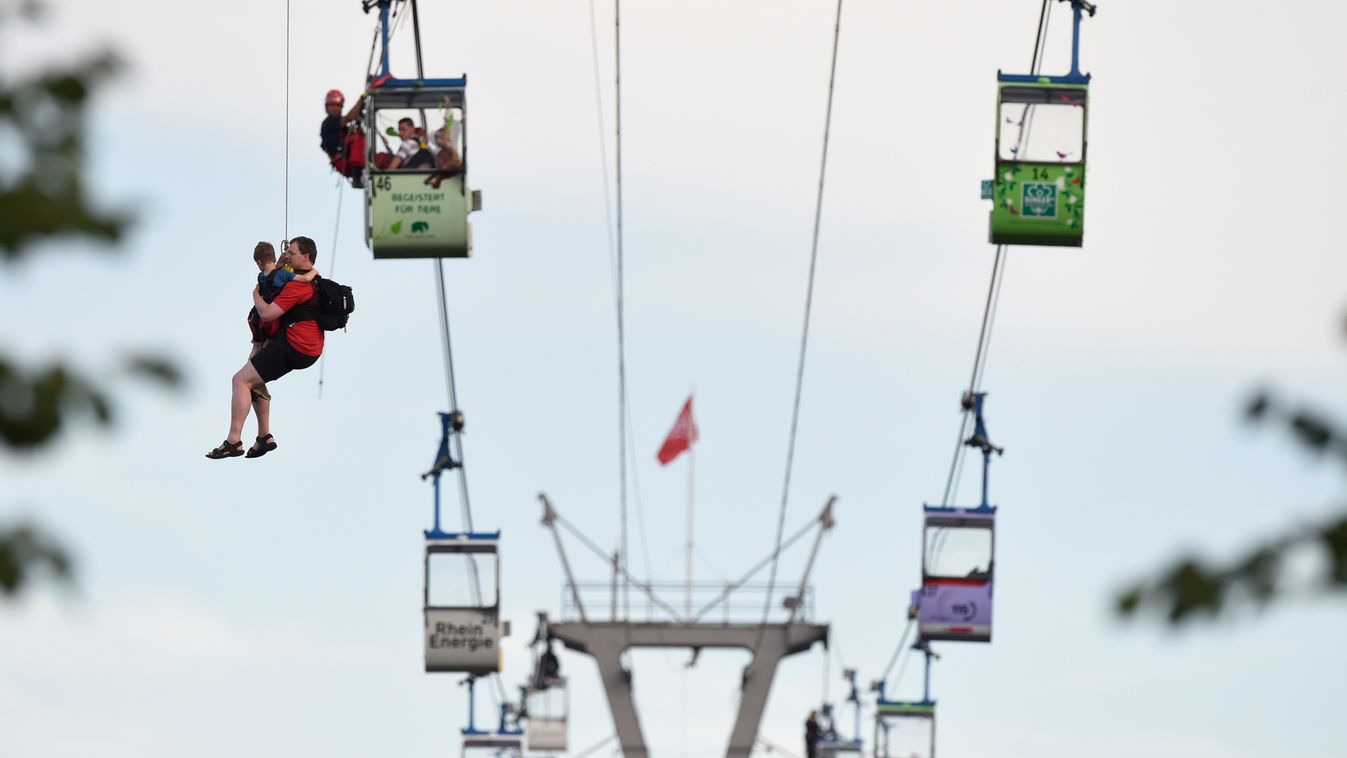 cable car GONDOLA RESCUE Members of the fire service rescue people from cable car gondolas, in Cologne, Germany, 30 July 2017. A gondola of a cable car across the river Rhine became stuck on Sunday. Photo: Rainer Jensen/dpa 