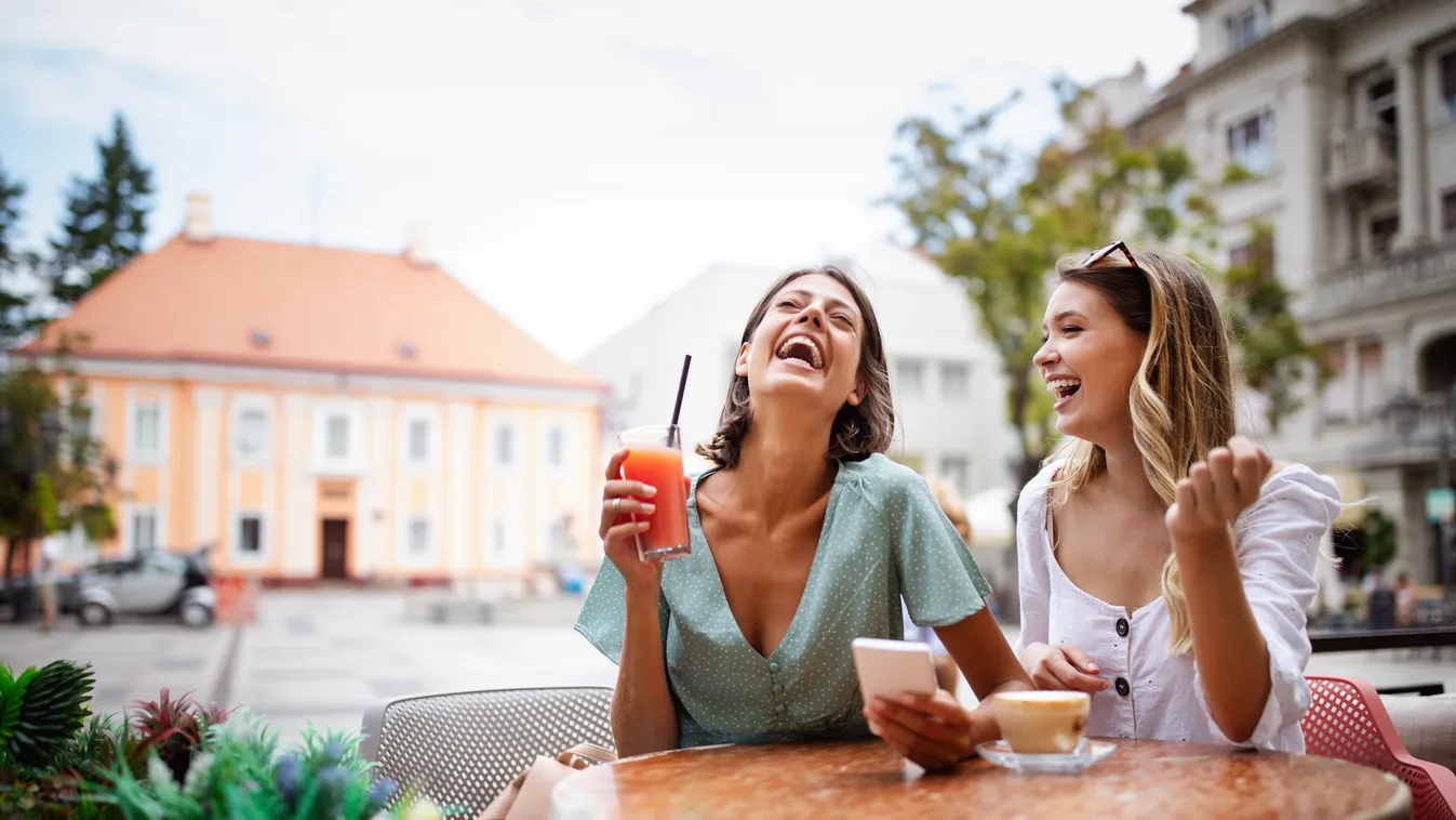 Technology, friendship and people concept. Happy young women with smartphone at outdoor cafe cafe female coffee happy friends mobile phone technology travel women person people young friendship smiling girl drink caucasian cell together beautiful tourism 