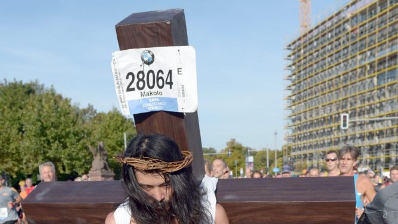 Berlin, 2014. szeptember 28.
Hátán óriási fakereszttel fut egy mezítlábas futó a 41. berlini maratonon 2014. szeptember 28-án. A 40 ezer indulóval rajtoló idei berlini maratont a kenyai Dennis Kimetto nyerte meg 2:02:57 órás világcsúccsal. (MTI/EPA/Rainer