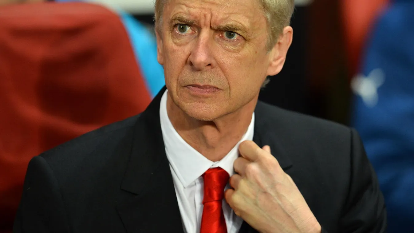 529414865 Arsenal's French manager Arsene Wenger takes his seat for the UEFA Champions League round of 16 first leg football match between Arsenal and Monaco at the Emirates Stadium in London on February 25, 2015.  AFP PHOTO / GLYN KIRK 