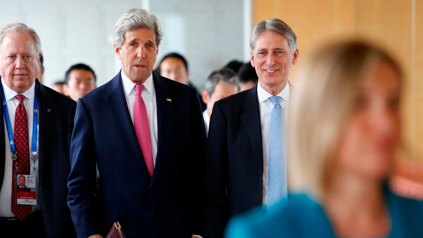 Horizontal US Secretary of State John Kerry (C) talks with Britain's Foreign Secretary Philip Hammond (R) as they arrive to participate in the first working session of the G7 Foreign Ministers' Meeting in Hiroshima on April 10, 2016.
The gathering is part