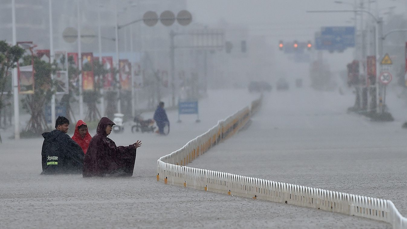 ce SQUARE FORMAT (151004) -- HAIKOU, Oct. 4, 2015 (Xinhua) -- People walk on waterlogged road in Haikou, south China's Hainan Province, Oct. 4, 2015. Typhoon Mujigae, the 22nd typhoon this year, has brought heavy rain in Haikou Sunday. (Xinhua/Guo Cheng) 