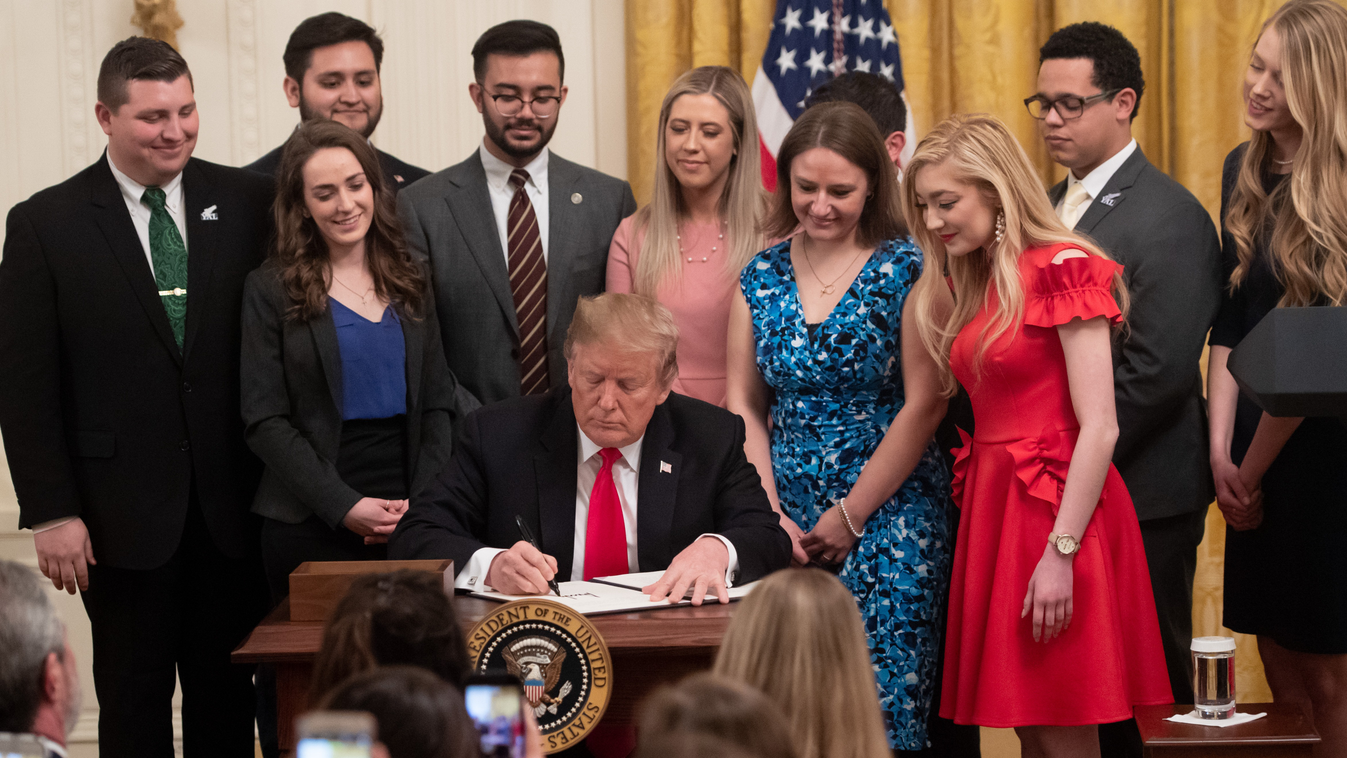 Horizontal SIGNING OF AN AGREEMENT US President Donald Trump signs an executive order to protect free speech on college campuses during a ceremony in the East Room of the White House in Washington, DC, March 21, 2019. (Photo by SAUL LOEB / AFP) 