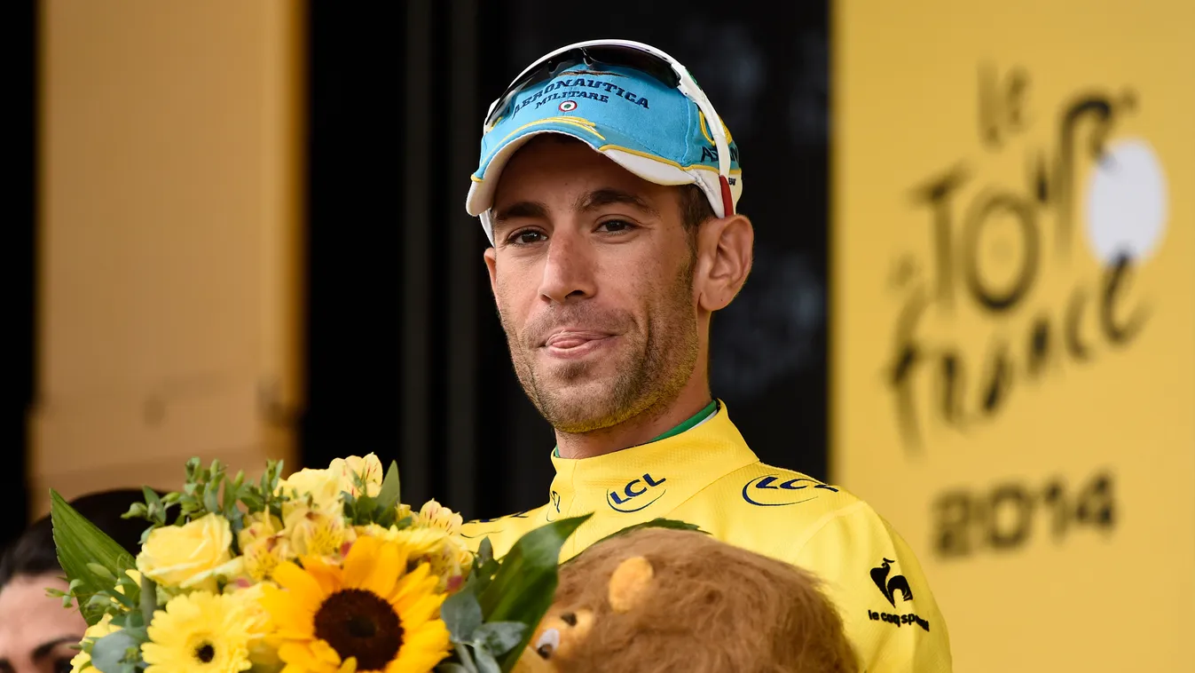 496135819 Italy's Vincenzo Nibali celebrates his overall leader yellow jersey on the podium at the end of the 208.5 km nineteenth stage of the 101st edition of the Tour de France cycling race on July 25, 2014 between Maubourguet Pays du Val d'Adour and Be