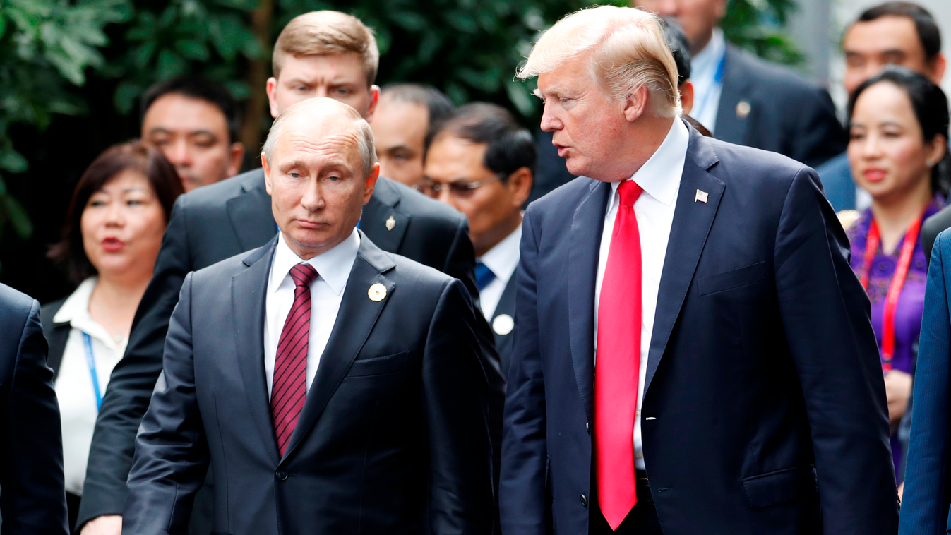Horizontal US President Donald Trump (R) and Russia's President Vladimir Putin talk as the make their way to take the "family photo" during the Asia-Pacific Economic Cooperation (APEC) leaders' summit in the central Vietnamese city of Danang on November 1
