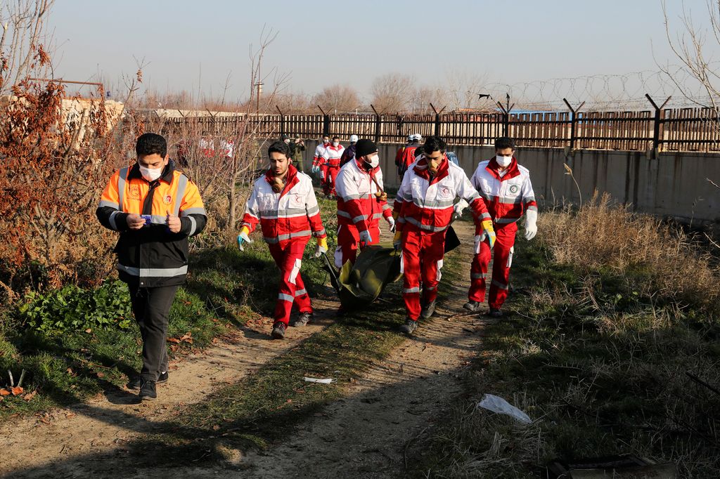 Sahriár, 2020. január 8.
Hullazsákot visznek a Vörös Félhold segélyszervezet munkatársai a lezuhant Boeing 737-es típusú ukrán utasszállító repülőgép balesetének helyszínén, az iráni Sahriár város közelében 2020. január 8-án. A légi jármű hajnalban zuhant le 167 utassal és 9 fős személyzettel a fedélzetén, kevéssel a teheráni Khomeini Imám repülőtérről történt felszállás után. A szerencsétlenséget senki sem élte túl.
MTI/AP/Ibrahim Norúzi 