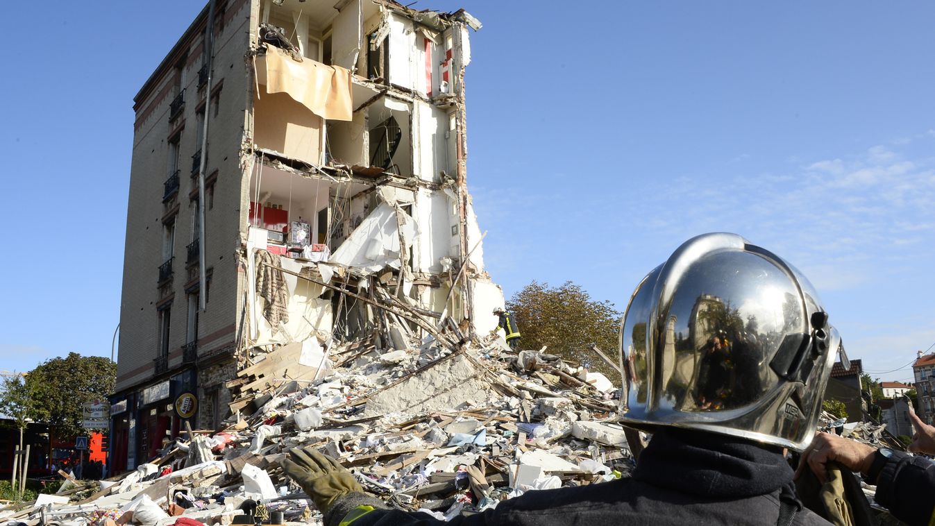 Firefighters inspect the site where a four-storey residential building collapsed following a blast in Rosny-sous-Bois in the eastern suburbs of Paris on August 31, 2014. Local authorities have not yet determined what caused the blast that led to the colla