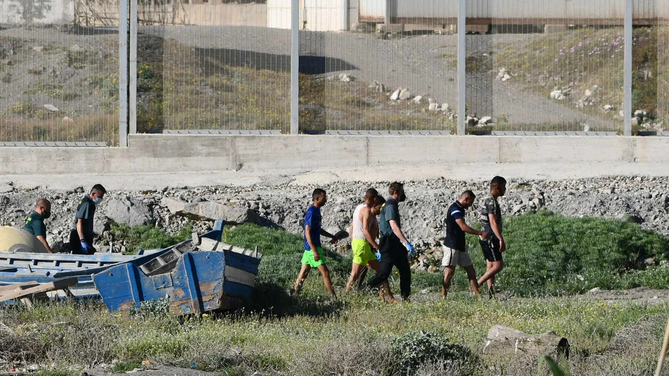 migration Horizontal Migrants speak with Spanish Civil guards after swimming to the Spanish enclave of Ceuta from neighbouring Morocco on May 17, 2021. - More than 80 migrants, including some minors, set off in the early hours of Monday from beaches a few