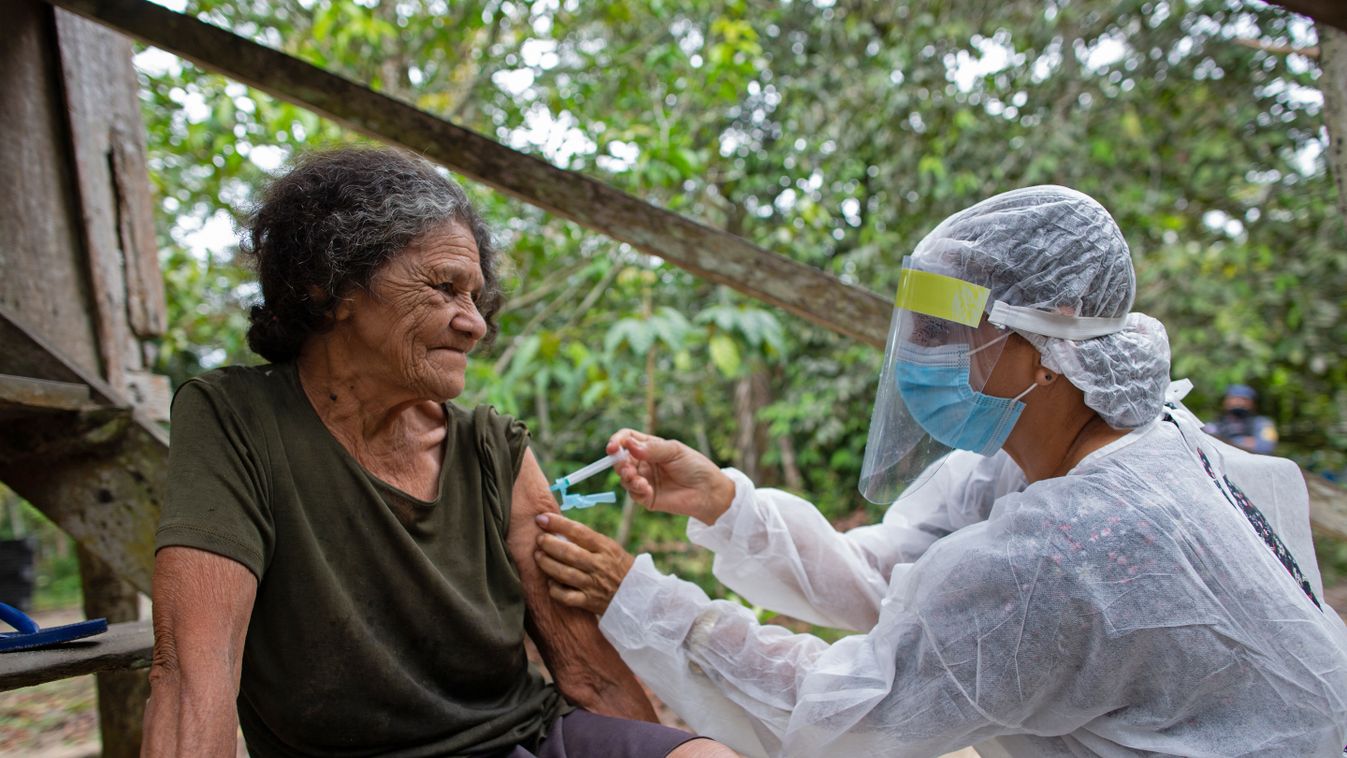 pandemic health virus vaccines Horizontal Maria Ferreira, 74, is vaccinated by a health worker with a dose of Oxford-AstraZeneca COVID-19 vaccine in the Nossa Senhora Livramento community on the banks of the Rio Negro near Manaus, Amazonas state, Brazil o