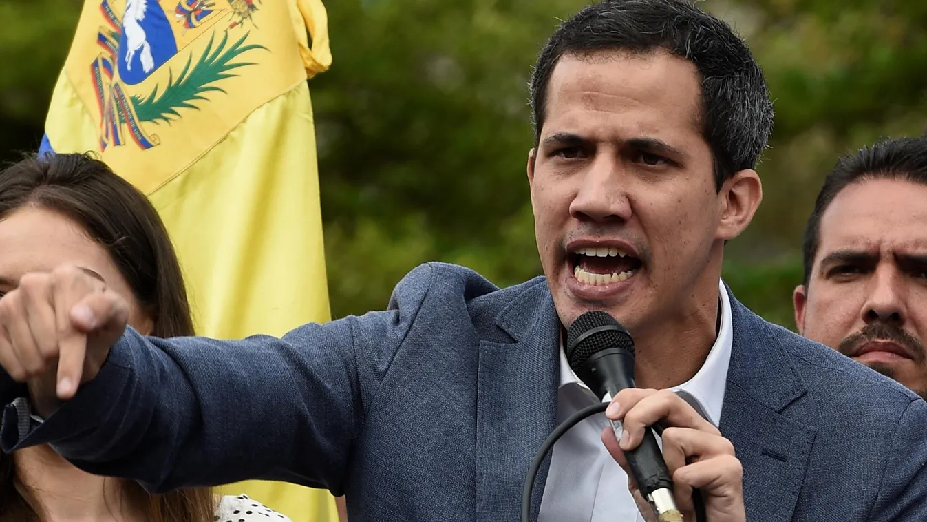 Vertical DEMONSTRATION The head of Venezuela's National Assembly and the country's self-proclaimed "acting president" Juan Guaido speaks to a crowd of opposition supporters during a rally in Caracas, on January 26, 2019. (Photo by Federico PARRA / AFP) 