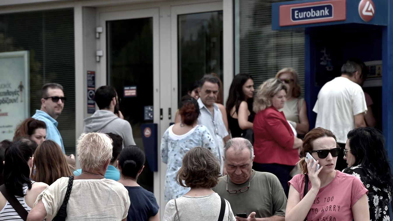 People queue at a national Bank of Greece ATM in central Athens on June 27, 2015. Eurozone ministers meet in Brussels on June 27 for a crunch meeting after a shock call for a referendum by Greek Prime Minister Alexis Tsipras threw a push to avert a defaul