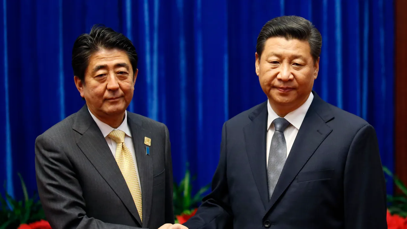 - China's President Xi Jinping (R) shakes hands with Japan's Prime Minister Shinzo Abe (L) at the Great Hall of the People on the sidelines of the Asia-Pacific Economic Cooperation (APEC) Summit in Beijing on November 10, 2014.  Top leaders and ministers 