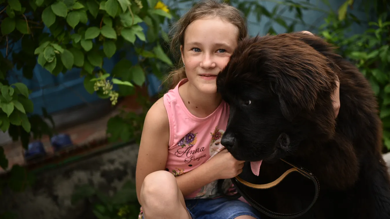 Dasha Yaitskaya with Newfoundland puppy, a gift from Russian President Vladimir Putin diver SQUARE FORMAT 