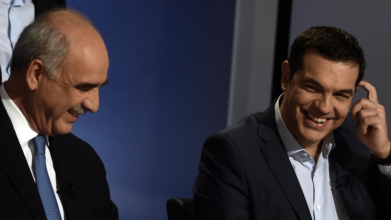 Former Prime Minister and leader of SYRIZA party Alexis Tsipras (C) and leader of the conservative New Democracy party Vangelis Meimarakis (L) smiles before a pre-election televised debate between the main party leaders in Athens on September 9, 2015. Wit
