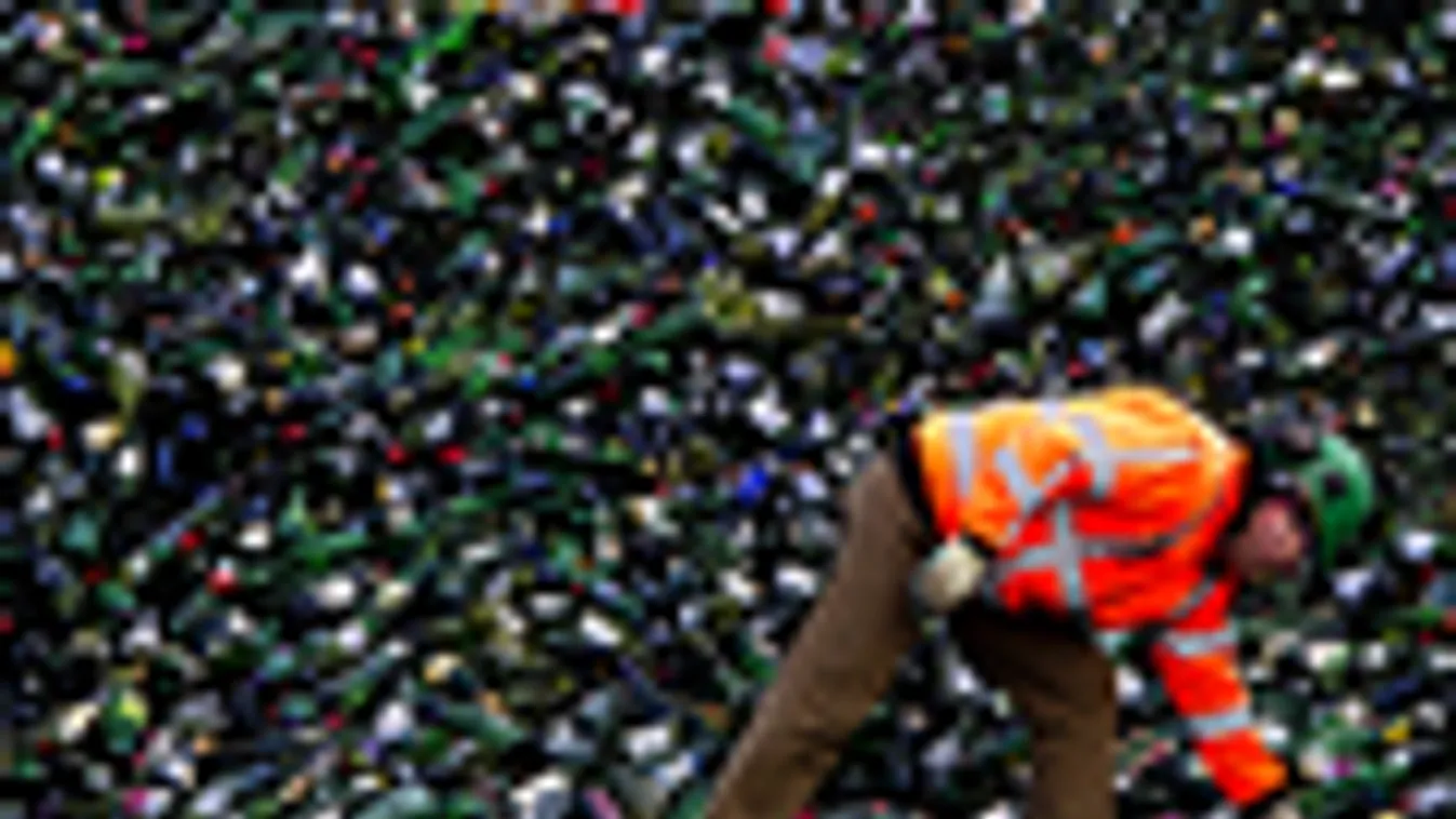 szemét, újrahasznosítás, szelektív szemétgyűjtés, üvegpalackokat pakol egy munkás a hollandiai Heijningen hulladékfeldolgozójában