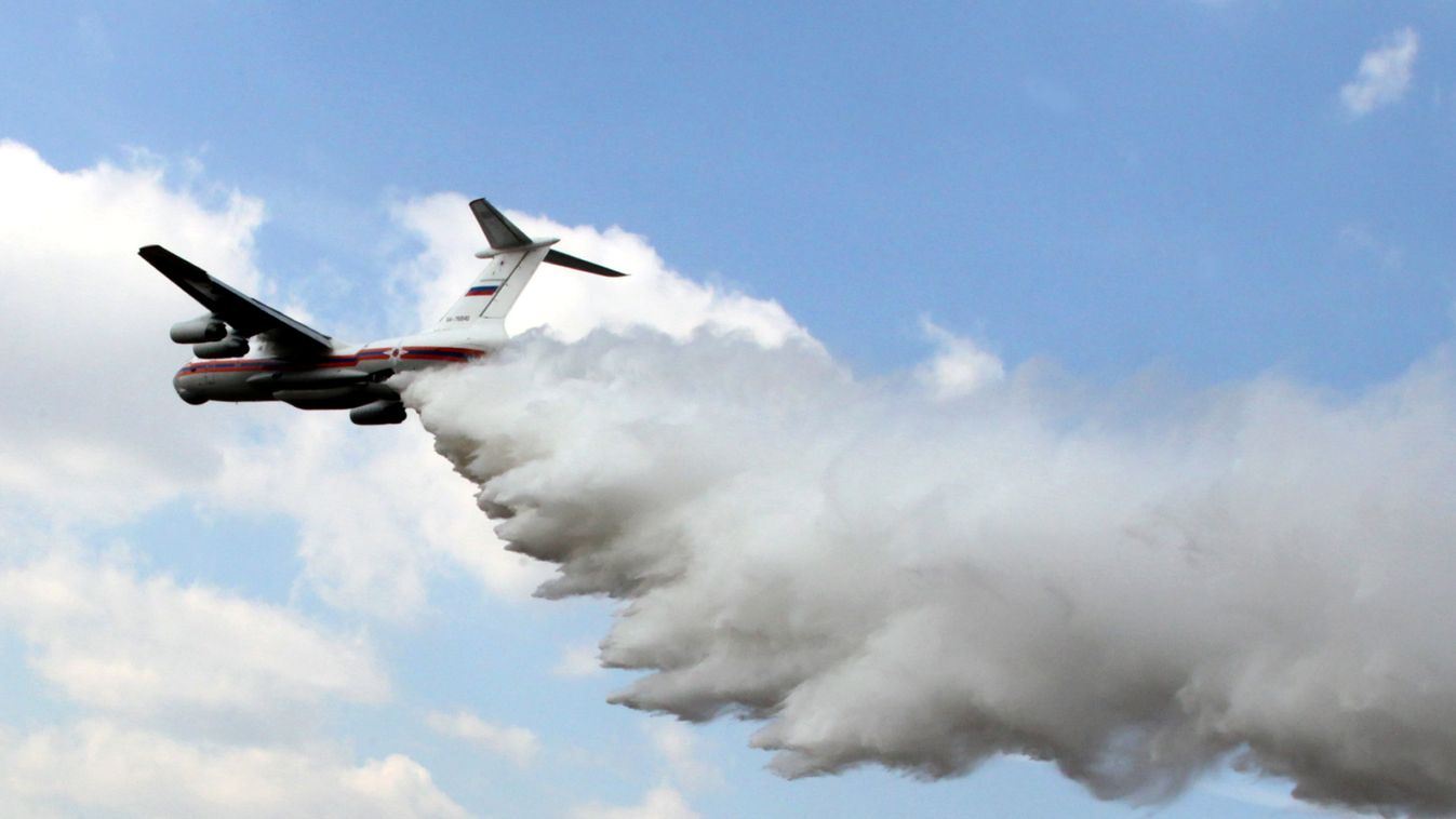 flying water cloud HORIZONTAL Emergency Situations Ministry IL-76 aircraft discharges water over a ground fire during special tactical exercises for fighting forest fires in the Orekhovo-Zuevskaya district near Moscow. 