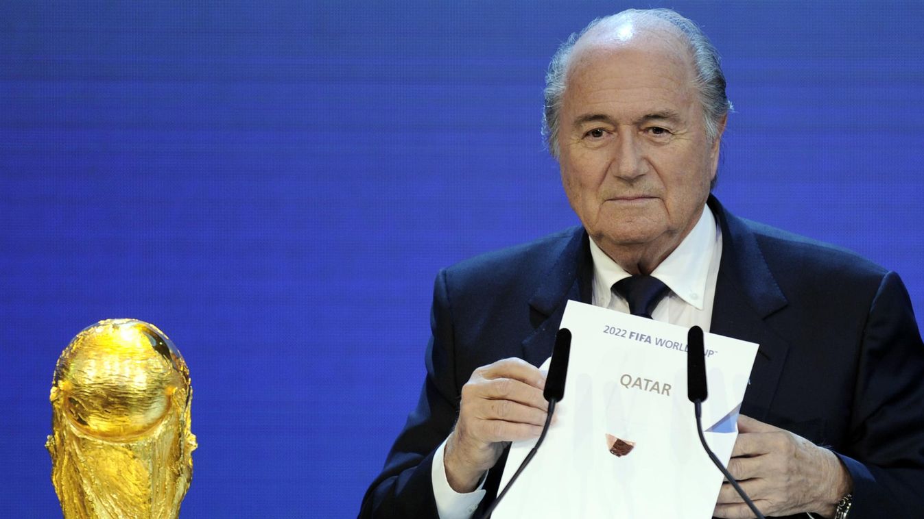 HORIZONTAL (FILES) A file picture taken on December 2, 2010 shows FIFA President Sepp Blatter holding up the name of Qatar during the official announcement of the 2022 World Cup host country at the FIFA headquarters  in Zurich. Football's world governing 