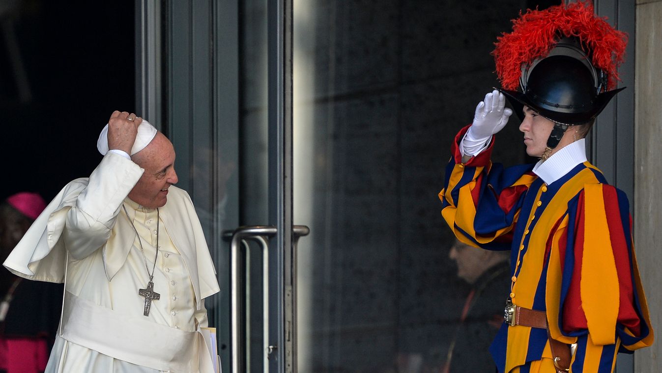 HORIZONTAL POPE VATICAN SWISS GUARD GREETING GESTURE RELIGION CATHOLIC RELIGION AMERICAN SHOT Pope Francis (C) holds his skullcup in front of a Swiss guard as he leaves at the end of the morning session of  the Synod on the Families, at the Vatican, on Oc