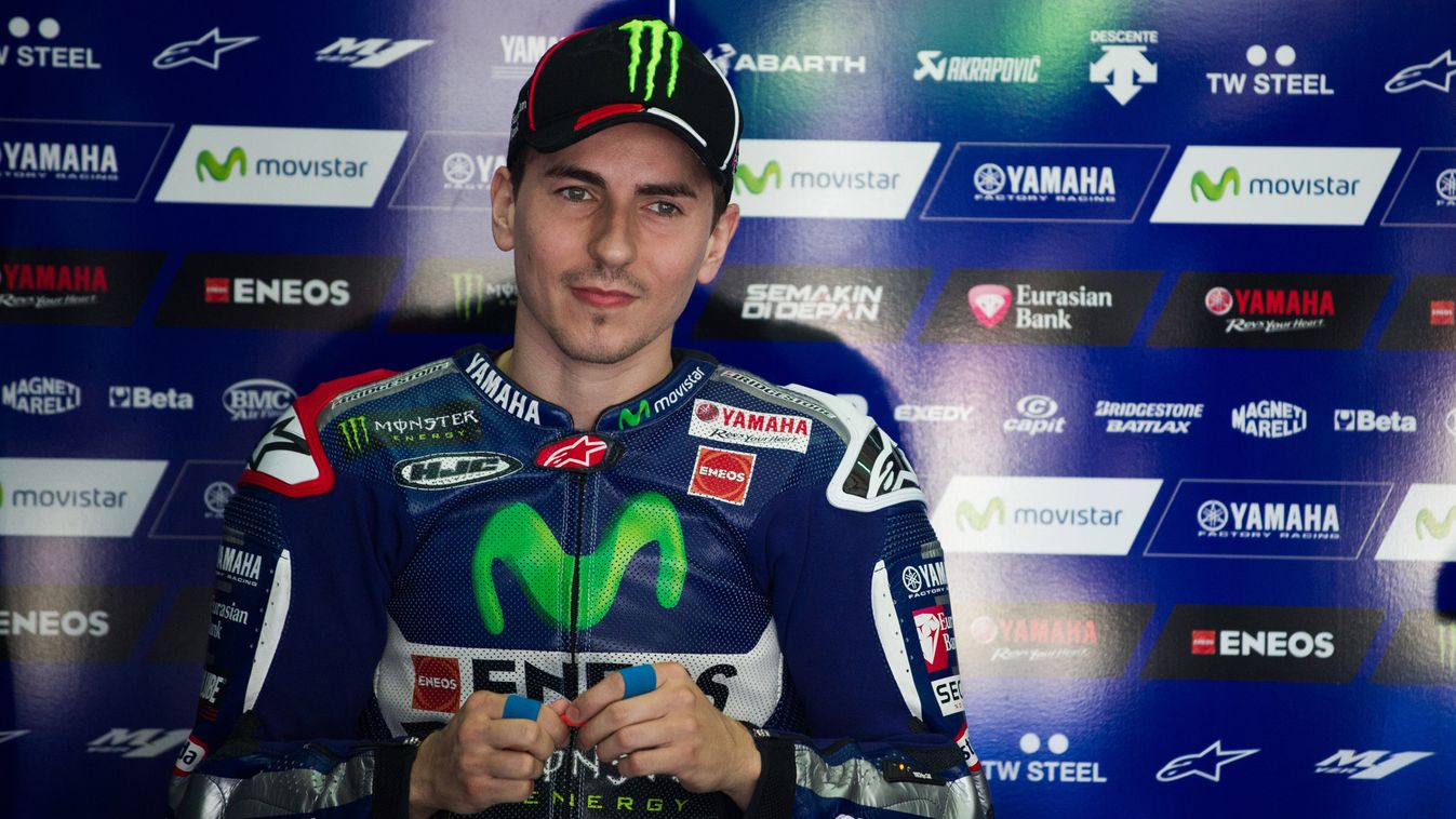 Movistar Yamaha rider Jorge Lorenzo of Spain looks on inside his team garage before the third and final day of MotoGP test races at the Sepang circuit outside Kuala Lumpur on February 25, 2015. AFP PHOTO / MOHD RASFAN 