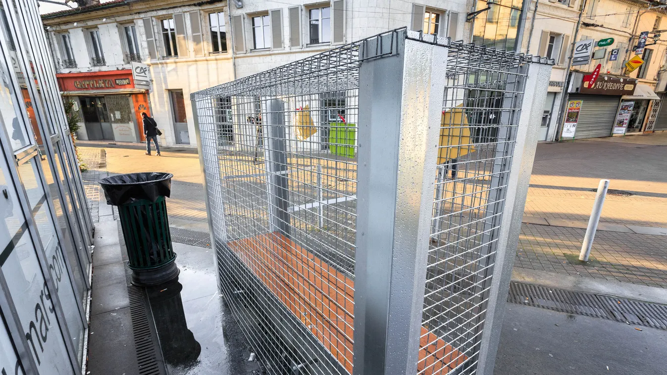 Wire grid has been placed around a public bench to prevent homeless from drinking alcohol and sleeping on it, on December 25, 2014 in Angouleme, southwestern France. Nine benches around the "Galerie du Champ-de-mars" shopping mall have been locked followi