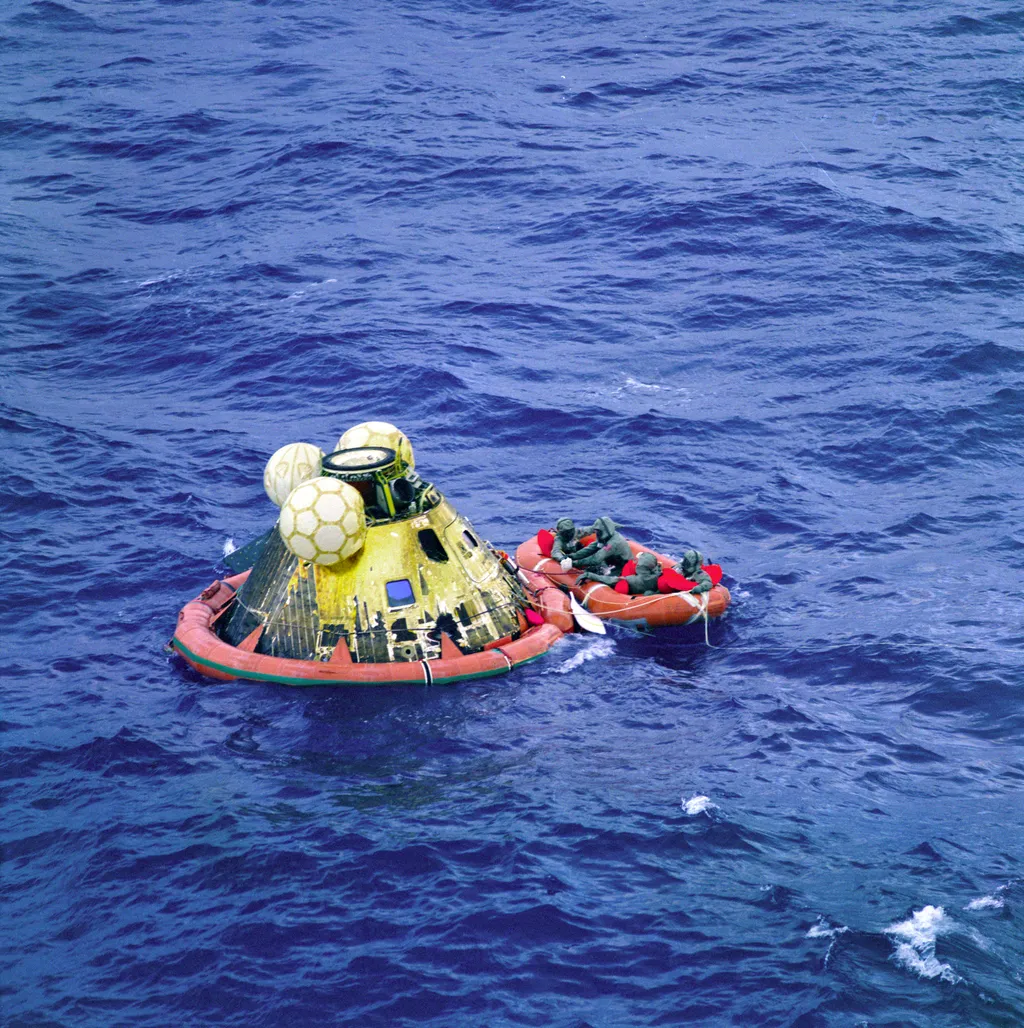 Apollo 11 BIG Biological Isolation Garment Buzz Aldrin Columbia Lunar Landing Michael Collins Mike Collins Moon Neil Armstrong Recovery Splashdown USS Hornet The Apollo 11 crew await pickup by a helicopter from the USS Hornet, prime recovery ship for the 
