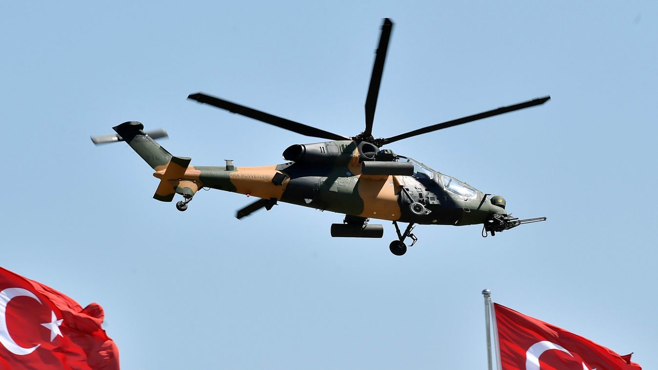 Horizontal An handout picture taken on August 30, 2015 and released by the Turkish Presidential Palace Press Office shows an helicopter flying over the sky as part of the aerobatic demonstration team of the Turkish Air Force and the national aerobatics te