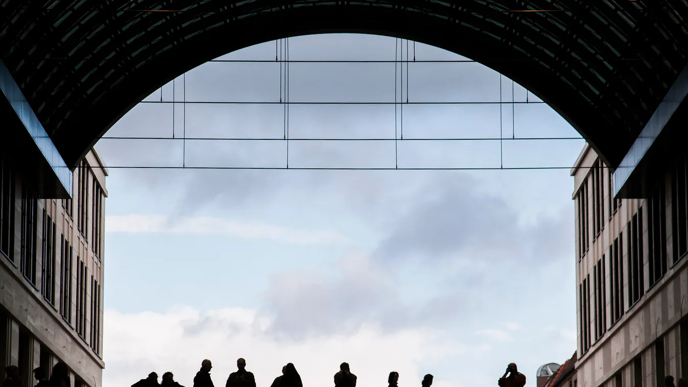 People stand on walkways at central square of LP12 Mall of Berlin, a new shopping mall opened on September 25, 2014 on the Leipziger Platz in Berlin. One of the biggest shopping centers of Berlin has been built on what used to be the east side of the Berl