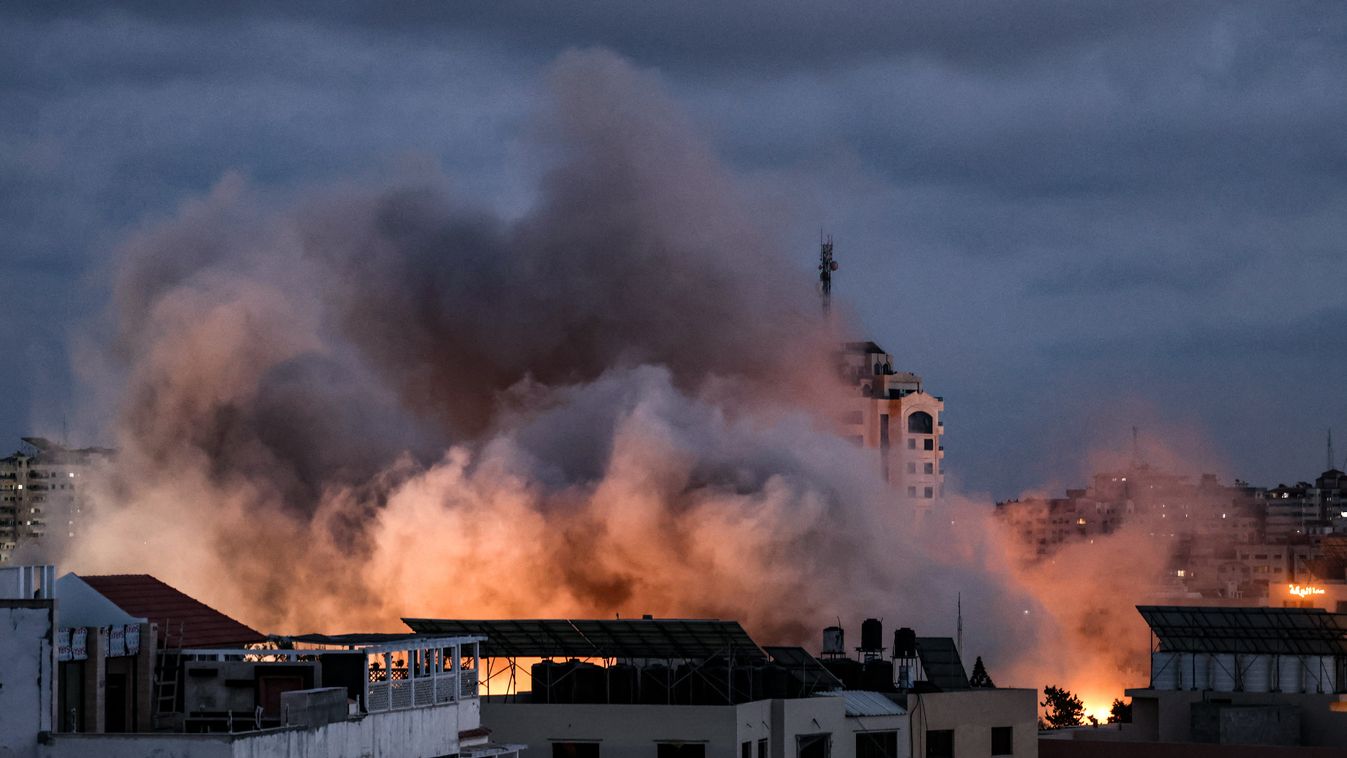 Horizontal Smoke billows above buildings during an Israeli air strike on Gaza City, on May 20, 2021. - Israel and the Palestinians are mired in their worst conflict in years as Israel pounds the Gaza Strip with air strikes and artillery, while Hamas milit