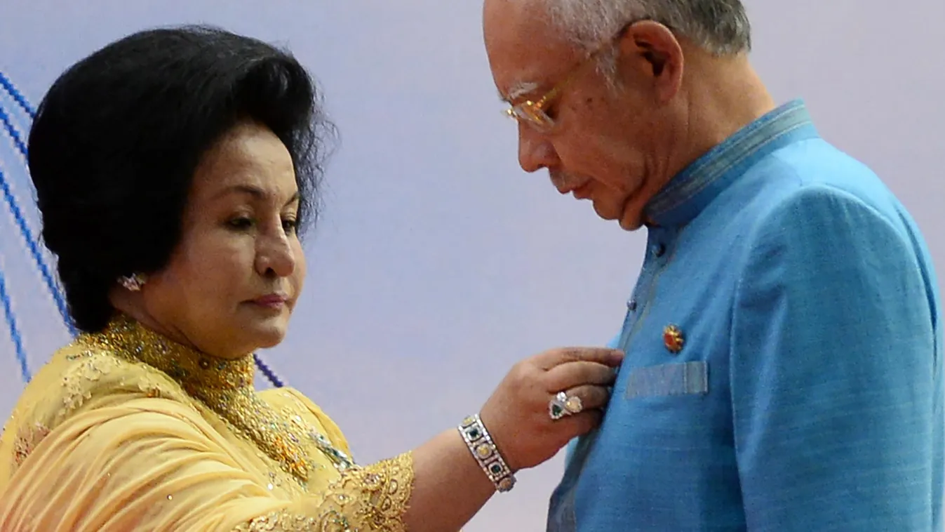crime politics Vertical (FILES) This file photo taken on April 26, 2015 shows Rosmah Mansor (L), wife of Malaysian Prime Minister Najib Razak (R), adjusting her husband's shirt as they wait for a group photo before a gala dinner in honour of ASEAN heads o