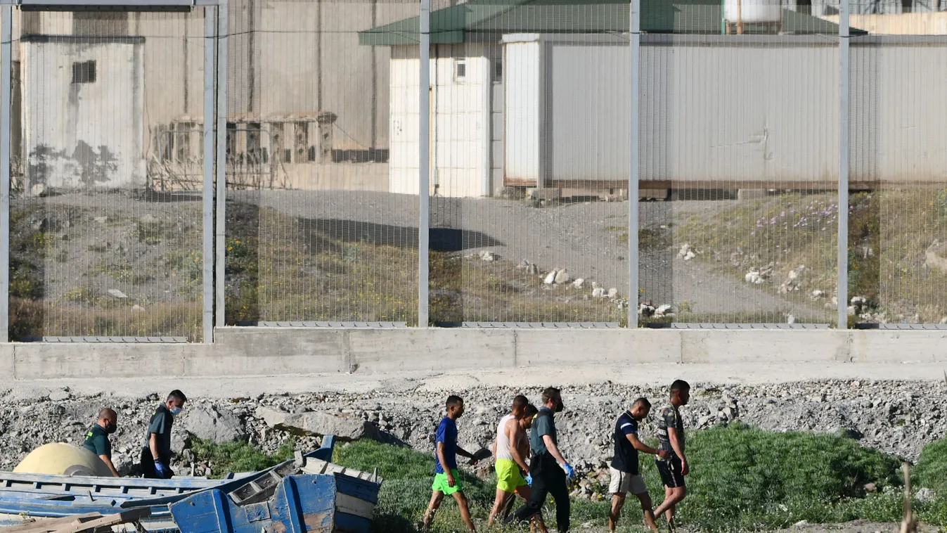 migration Horizontal Migrants speak with Spanish Civil guards after swimming to the Spanish enclave of Ceuta from neighbouring Morocco on May 17, 2021. - More than 80 migrants, including some minors, set off in the early hours of Monday from beaches a few