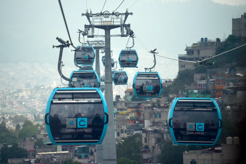 transport Horizontal Passengers travel on the cable car system dubbed Cablebus after its inauguration outskirts of Mexico City, on July 12, 2021. - Mexico City put into operation on Monday a cable car system that promises to save time for thousands of use