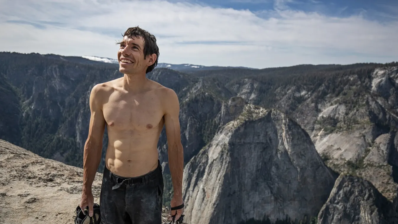 66320 Alex Honnold holds all of his climbing gear atop the summit of El Capitan. He just became the first person to climb El Capitan without a rope. (National Geographic/Jimmy Chin) 