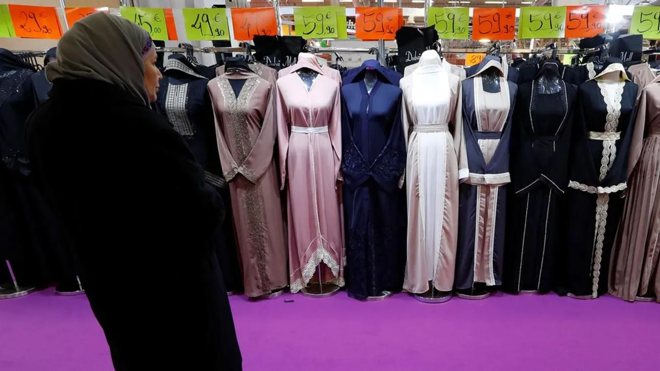 A visitor looks at women's clothes during the 35th annual meeting of French Muslims, the cultural and festive event in Le Bourget 