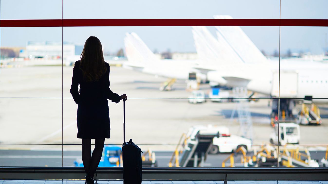 Young woman in the airport Luggage Travel People Traveling Businesswoman First Class Girls Women Looking Through Window Urgency Abstract Aerospace Industry Global Communications Airport Lounge Waiting Flying Commuter Business Travel One Person Wide Concep