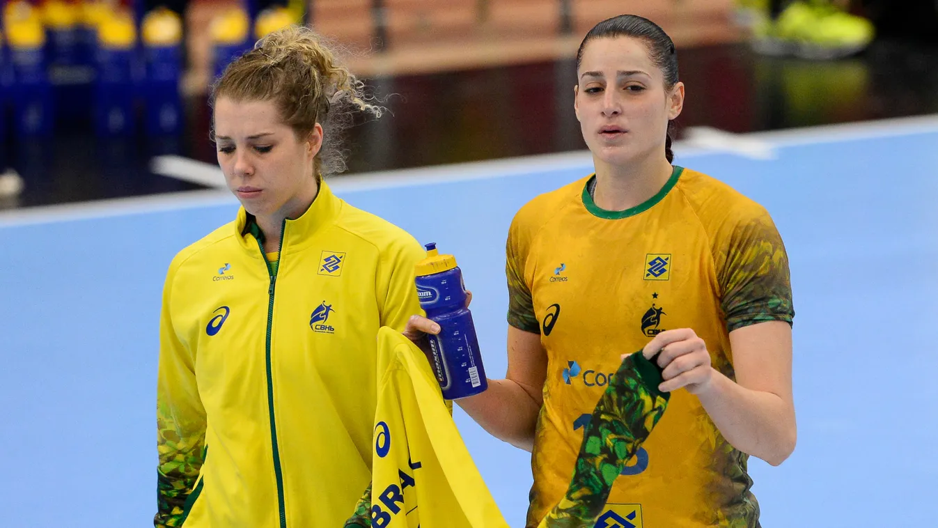 Brazil's Eduarda Amorim (R) and goalkeeper Barbara Arenhart react at the end of the 2015 Women's Handball World Championship match between Brazil and Romania at the Sydbank Arena in Kolding on December 13, 2015 
