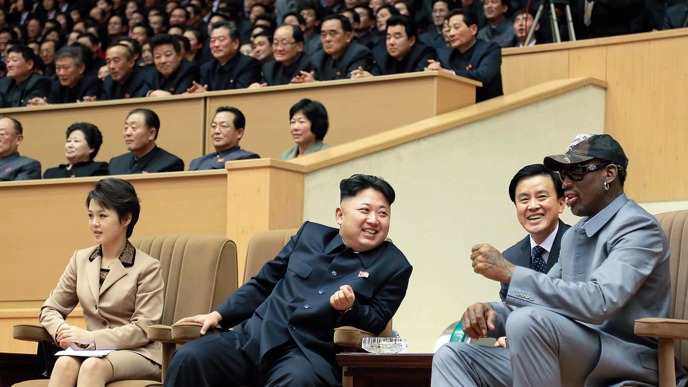 This photo taken on January 08, 2014 and released by North Korea's official Korean Central News Agency (KCNA) on January 9, 2014 shows North Korean leader Kim Jong-Un (C), his wife Ri Sol-Ju (L) and former US basketball star Dennis Rodman (R) watching a b