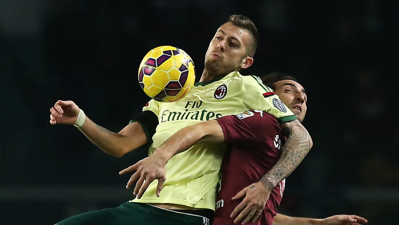 504225795 AC Milan's French forward Jeremy Menez (L) fights for the ball with Torino's defender Emiliano Moretti during the Italian Serie A football match Torino Vs AC Milan on January 10, 2015 at the "Olympic Stadium" in Turin.  AFP PHOTO / MARCO BERTORE