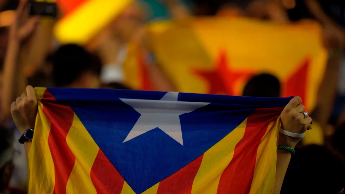 A people hold "Esteladas" (pro-independence Catalan flags) before the results of the regional election in Barcelona on September 27, 2015. Catalans voted today in an election dubbed crucial for the future of Spain, with polls pointing to a win by separati