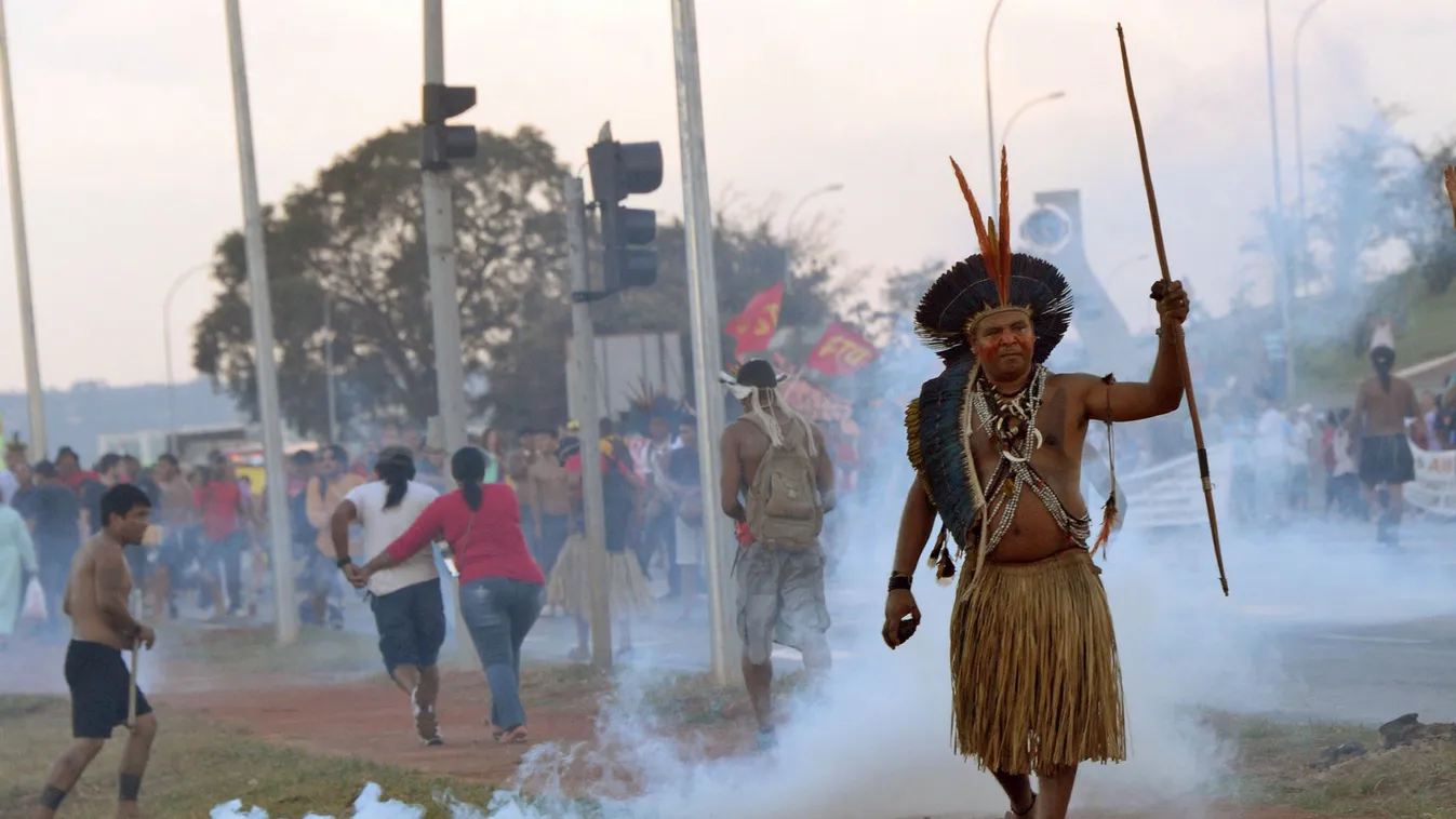 TOPSHOTS
An indigenou man protests against the upcoming FIFA World Cup in Brasilia on May 27, 2014. Police in the Brazilian capital fired tear gas Tuesday to break up a protest by Indian chiefs and groups opposed to the money being spent to host the World