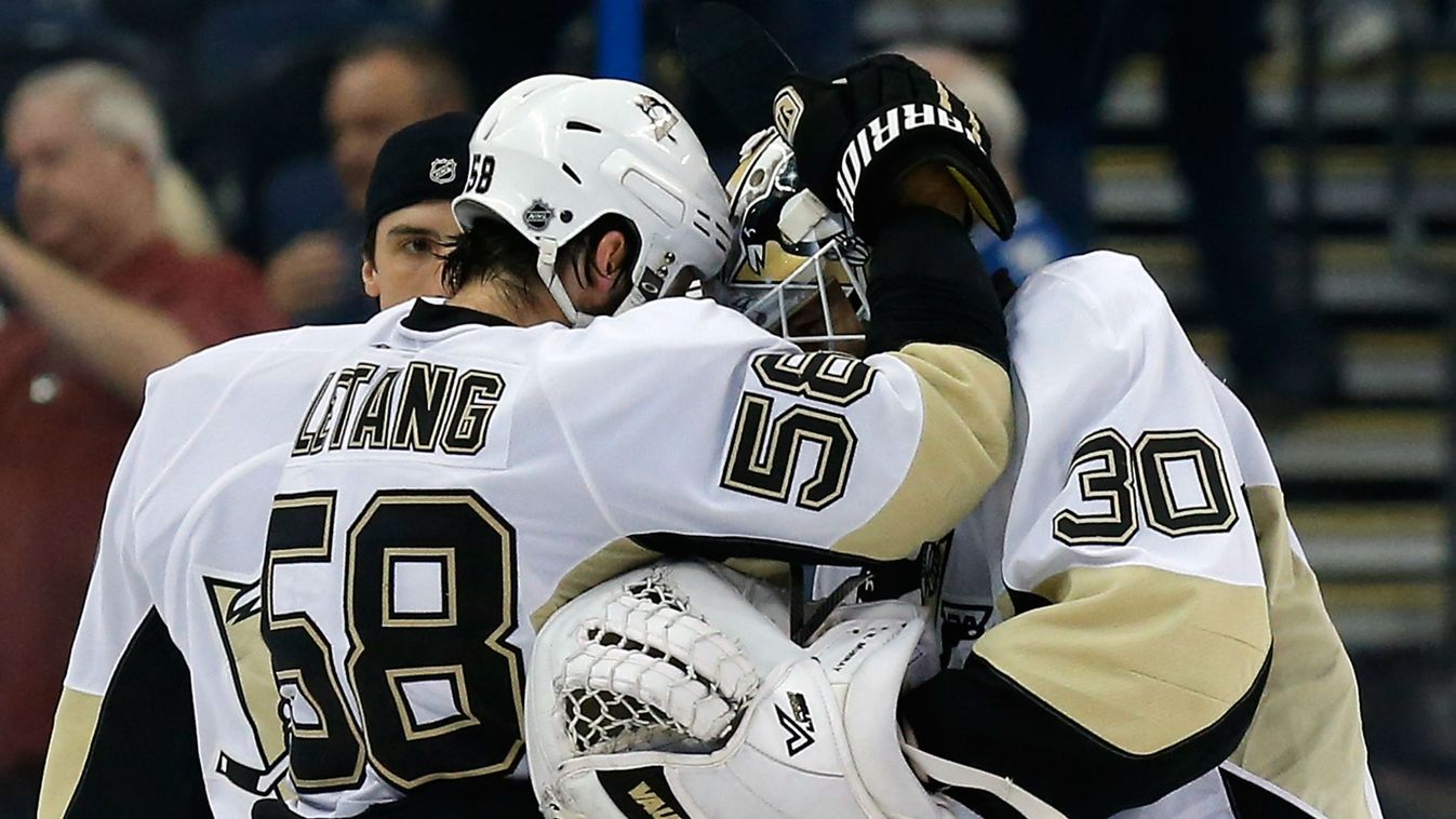 Matt Murray #30 of the Pittsburgh Penguins celebrates with his teammates Kris Letang #58 and Marc-Andre Fleury #29 after defeating the Tampa Bay Lightning 