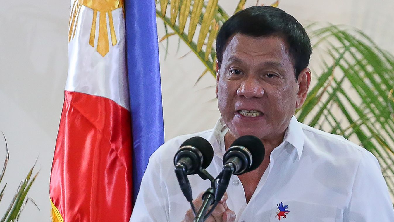 Horizontal Philippine President Rodrigo Duterte gestures during a press conference shortly after arriving from Singapore at Davao international airport in southern island of Mindanao early December 17, 2016.  
Duterte boasted again on December 16, he had 