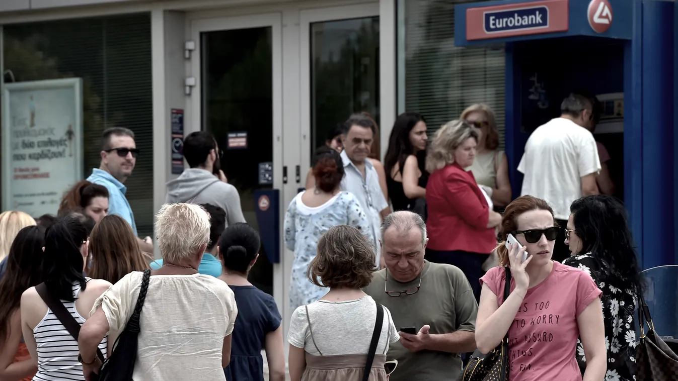 People queue at a national Bank of Greece ATM in central Athens on June 27, 2015. Eurozone ministers meet in Brussels on June 27 for a crunch meeting after a shock call for a referendum by Greek Prime Minister Alexis Tsipras threw a push to avert a defaul