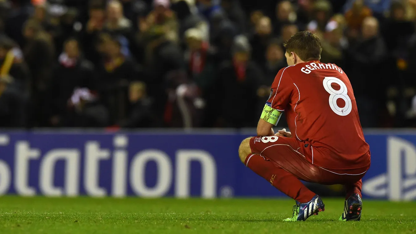 511785549 Liverpool's English midfielder Steven Gerrard crouches on the pitch after the final whistle of the UEFA Champions League group B football match between Liverpool and Basel at Anfield in Liverpool, north west England, on December 9, 2014. The fin