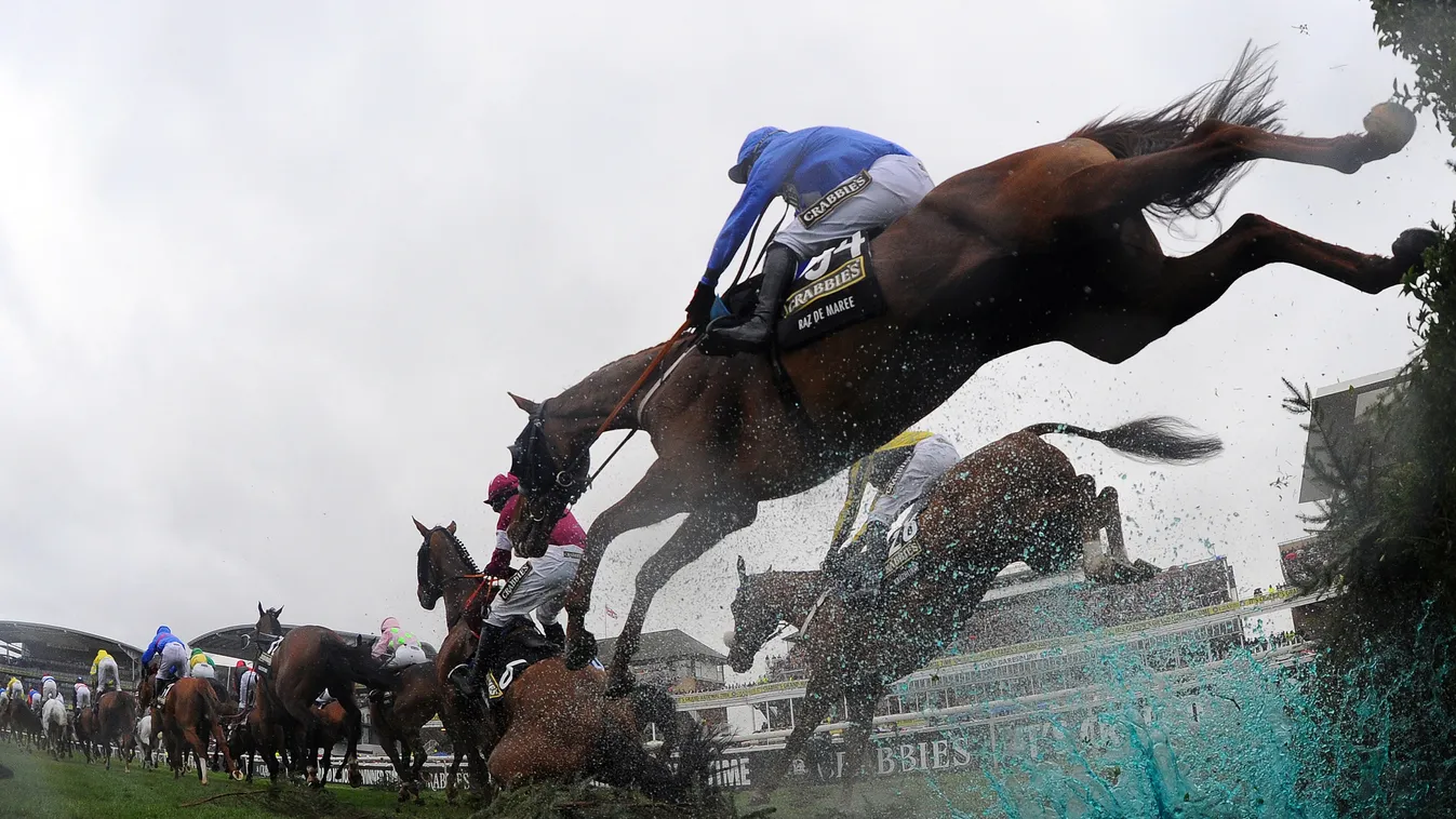 EQUESTRIANISM HORSE RACE LOW ANGLE SPORT-ACTION Raz de Maree ridden by Davy Condon (R) jumps the water jump during the Grand National horse race at Aintree Racecourse in Liverpool, north-west England, on April 5, 2014. The annual three day meeting culmina